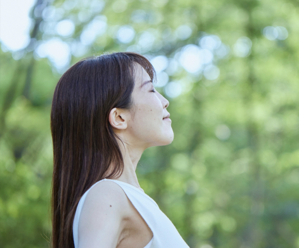 lady in nature feeling relaxed with self reflection exercises